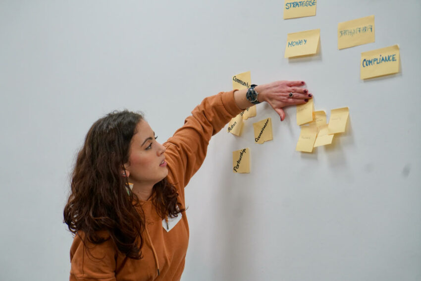 Hinde presenting using a whiteboard and post-it notes